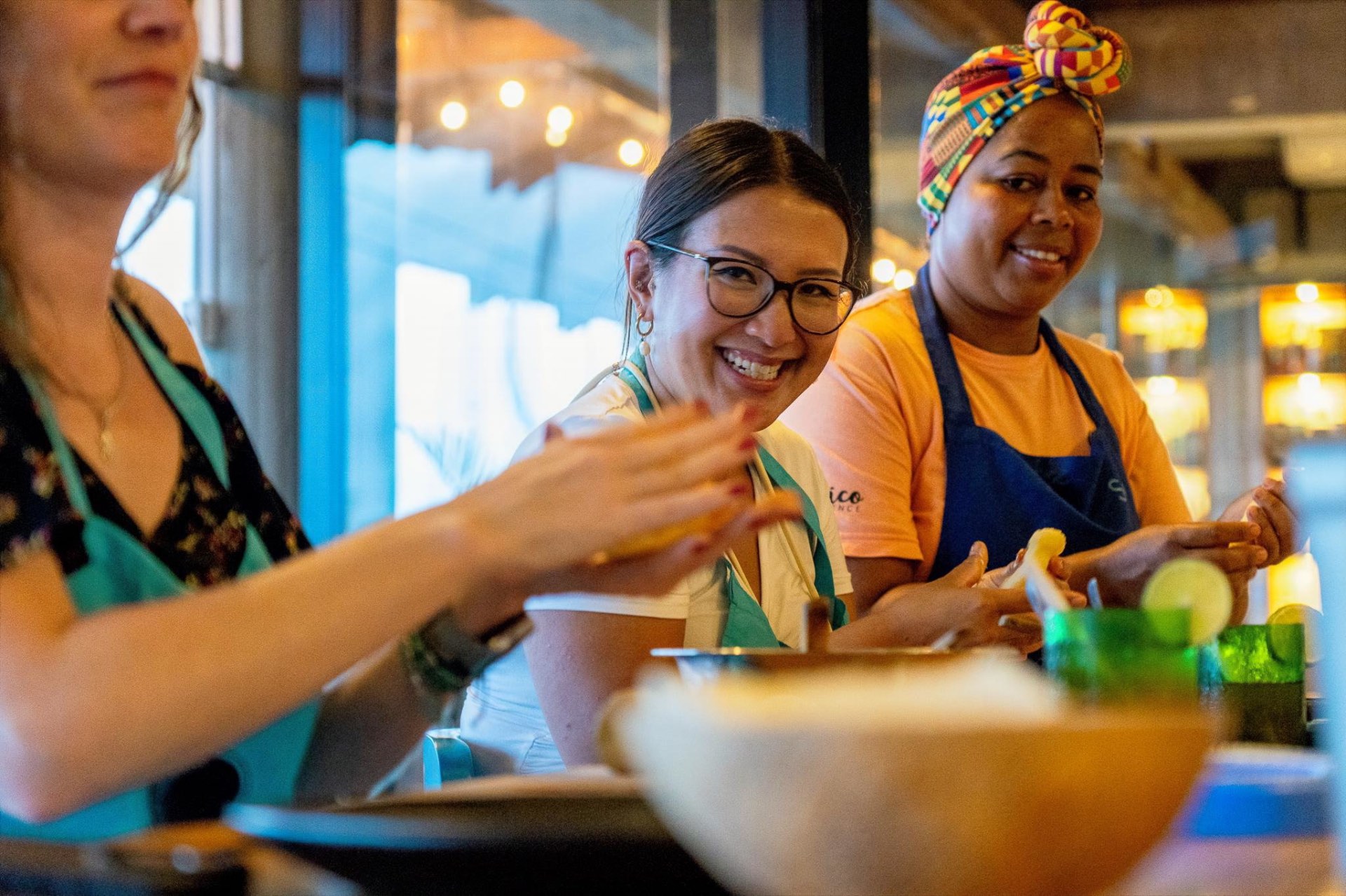 Guests smiling during a hands-on cooking experience at Lunático