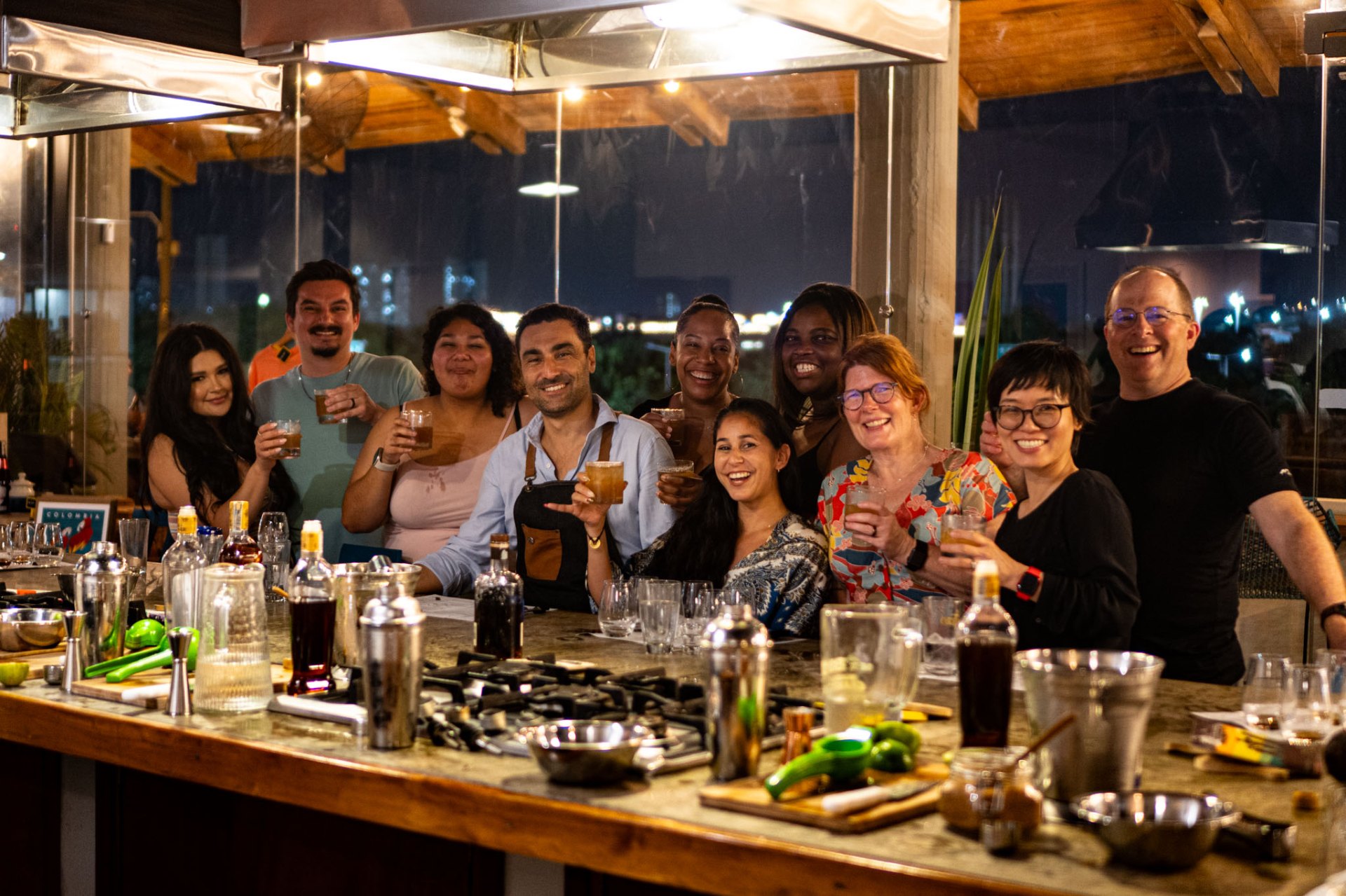 Group celebrating with drinks at a private Lunático culinary experience in Cartagena