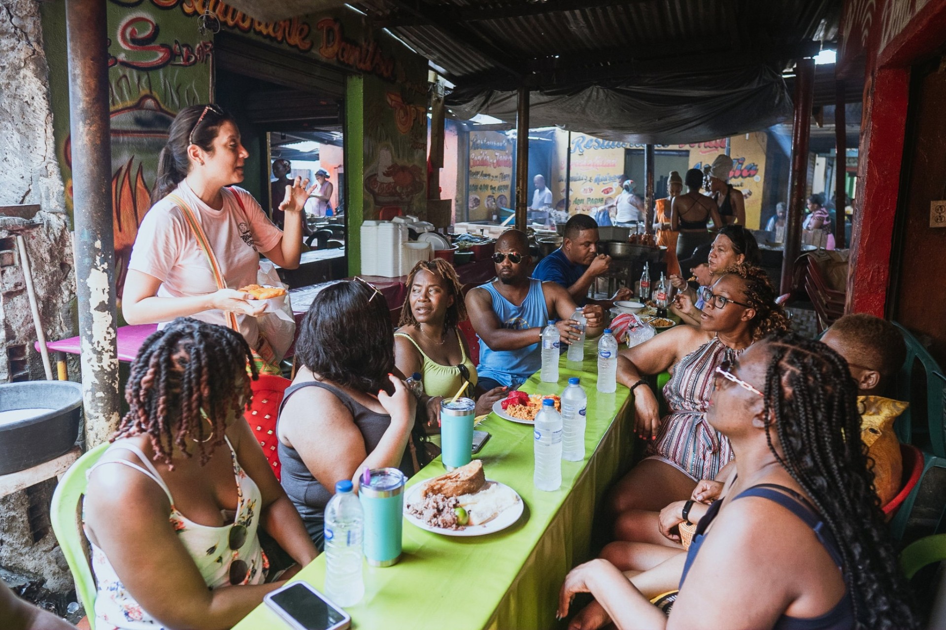 Group seated together at Bazurto tasting local food with the guide