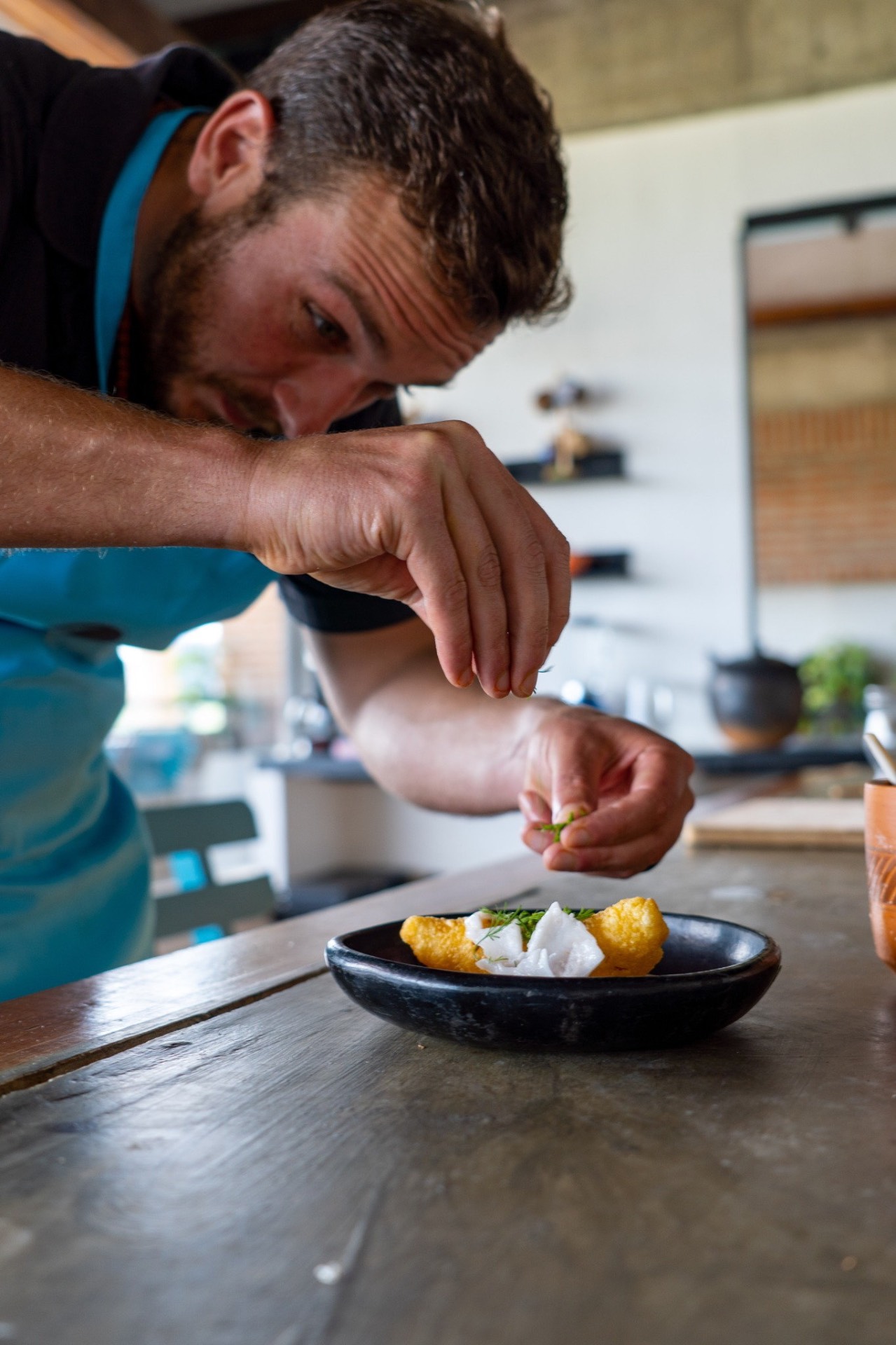 Chef plating ceviche during a Colombian ceviche workshop in Cartagena